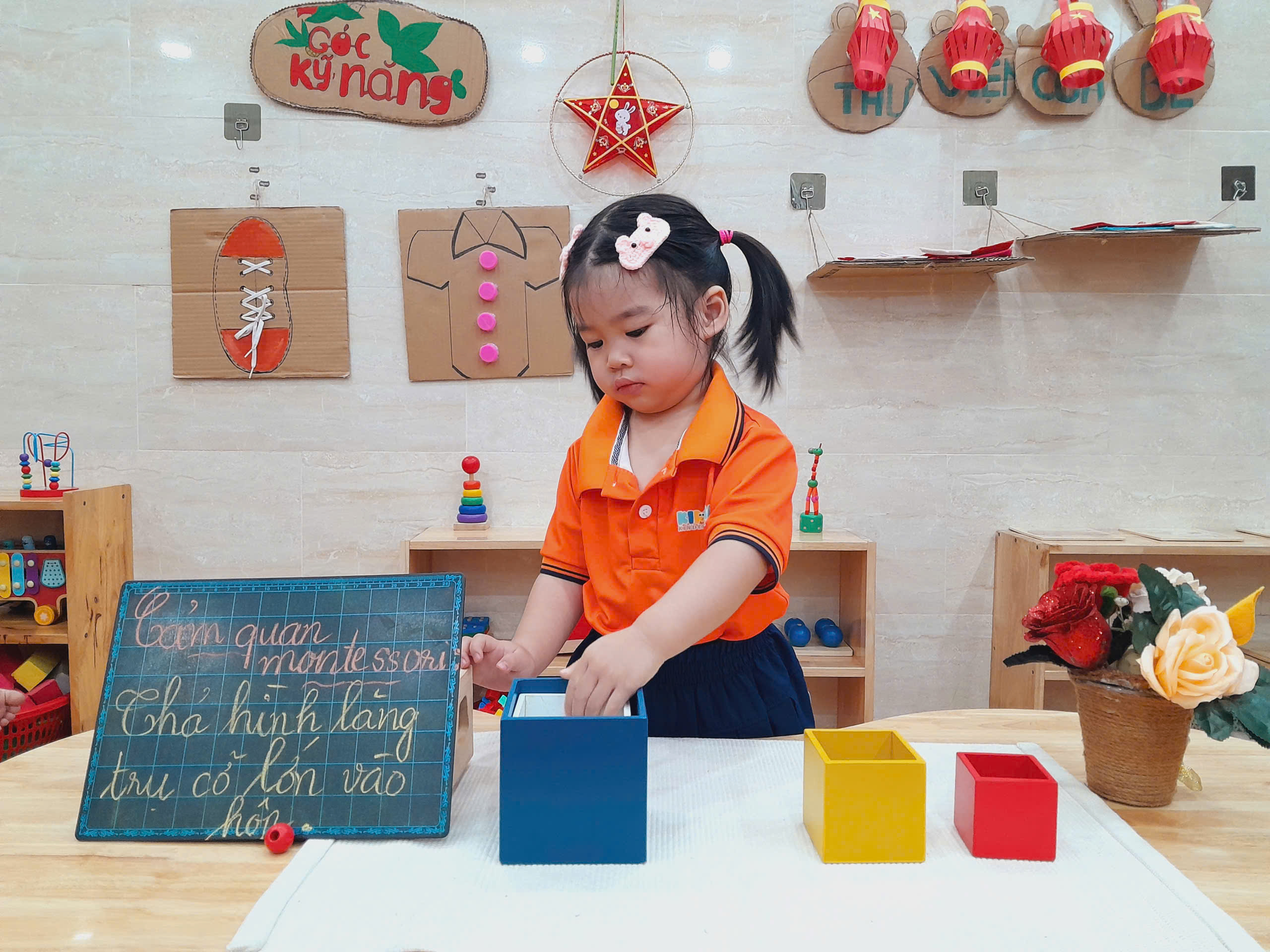 bé gái thả hình vào hộp montessori mầm non kim hà